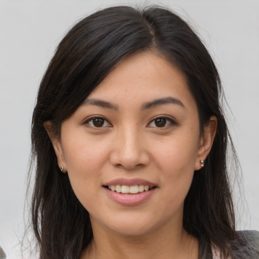 Joyful asian young-adult female with medium  brown hair and brown eyes