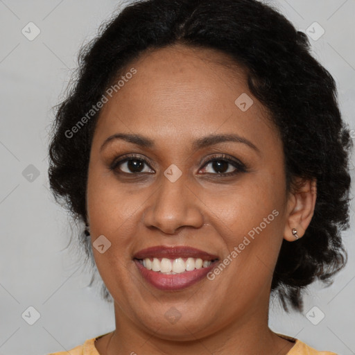 Joyful latino adult female with medium  brown hair and brown eyes