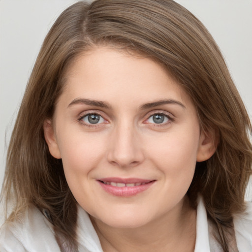 Joyful white young-adult female with medium  brown hair and grey eyes