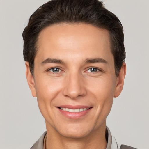 Joyful white adult male with short  brown hair and brown eyes