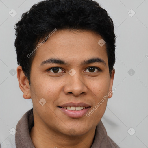 Joyful latino young-adult male with short  brown hair and brown eyes