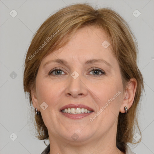 Joyful white adult female with medium  brown hair and grey eyes