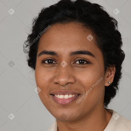 Joyful black young-adult female with short  black hair and brown eyes