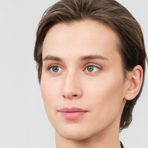 Joyful white young-adult female with medium  brown hair and green eyes