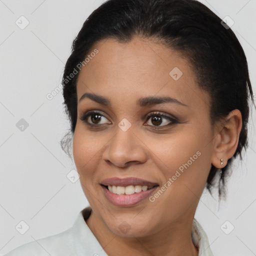 Joyful black young-adult female with medium  brown hair and brown eyes