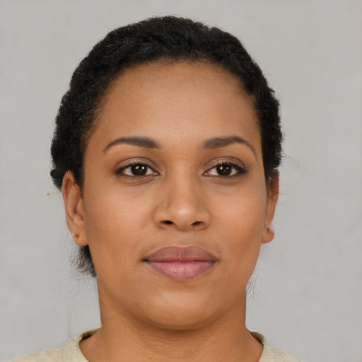 Joyful black young-adult female with short  brown hair and brown eyes