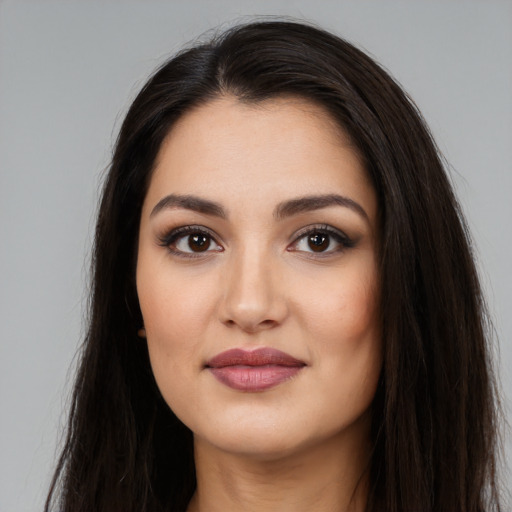 Joyful white young-adult female with long  black hair and brown eyes