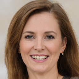 Joyful white adult female with medium  brown hair and brown eyes