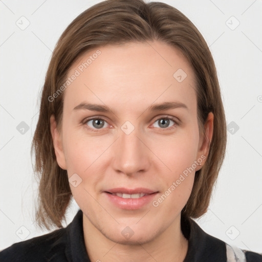 Joyful white young-adult female with medium  brown hair and grey eyes