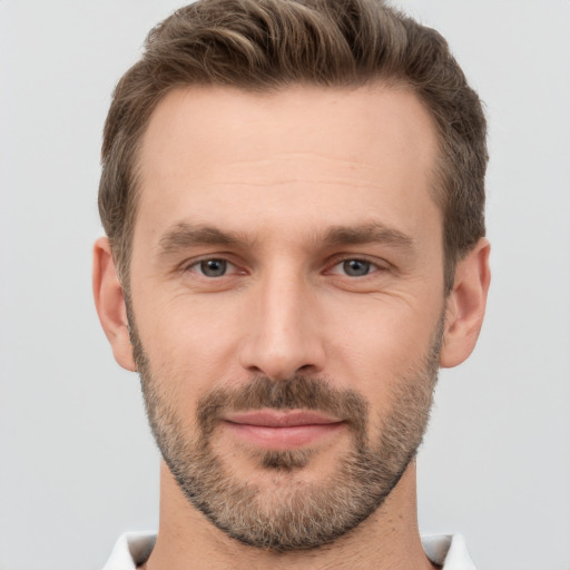 Joyful white young-adult male with short  brown hair and brown eyes