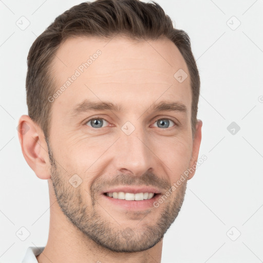 Joyful white young-adult male with short  brown hair and grey eyes