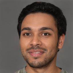 Joyful latino young-adult male with short  brown hair and brown eyes