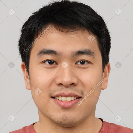 Joyful asian young-adult male with short  brown hair and brown eyes