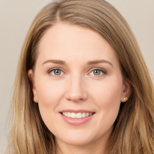 Joyful white young-adult female with long  brown hair and grey eyes