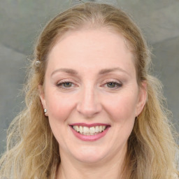 Joyful white young-adult female with medium  brown hair and blue eyes