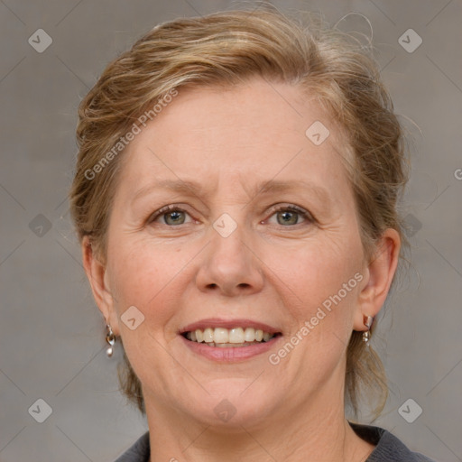 Joyful white adult female with medium  brown hair and blue eyes