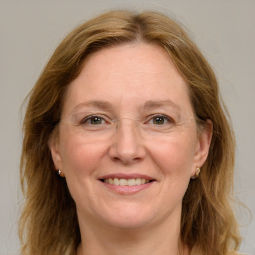 Joyful white adult female with medium  brown hair and blue eyes