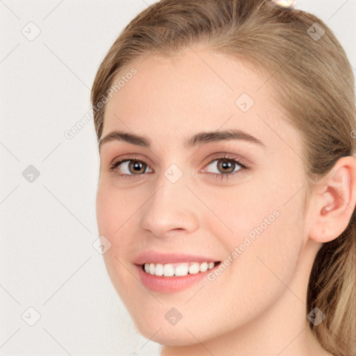 Joyful white young-adult female with long  brown hair and grey eyes