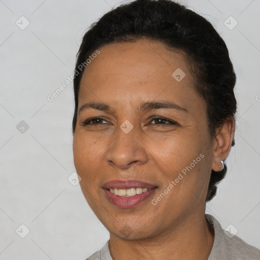 Joyful latino adult female with short  brown hair and brown eyes