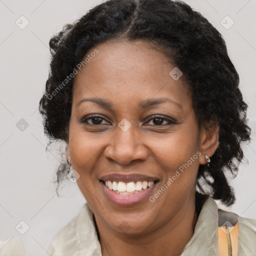 Joyful black adult female with medium  brown hair and brown eyes