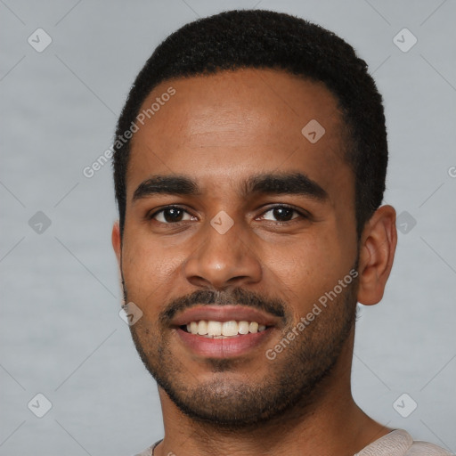 Joyful black young-adult male with short  black hair and brown eyes