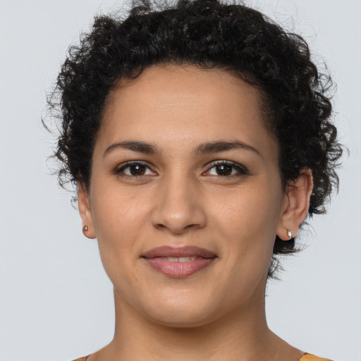 Joyful latino young-adult female with short  brown hair and brown eyes