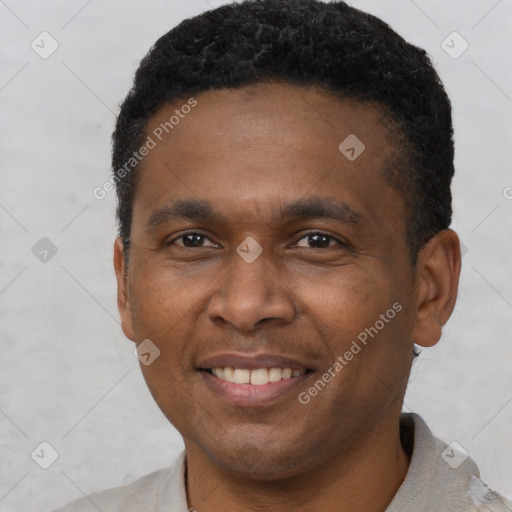 Joyful black adult male with short  black hair and brown eyes