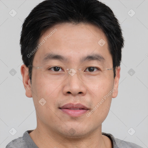 Joyful asian young-adult male with short  brown hair and brown eyes