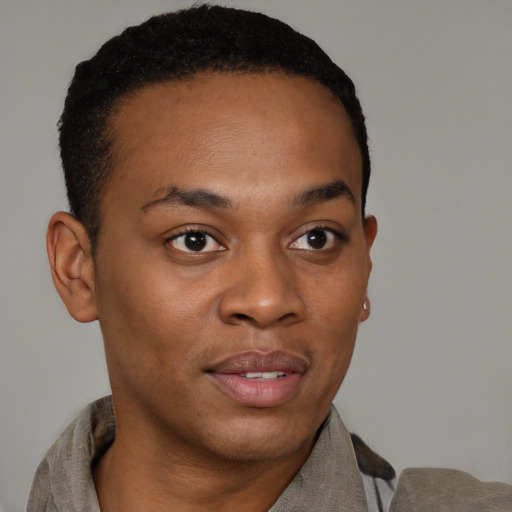 Joyful black young-adult male with short  brown hair and brown eyes