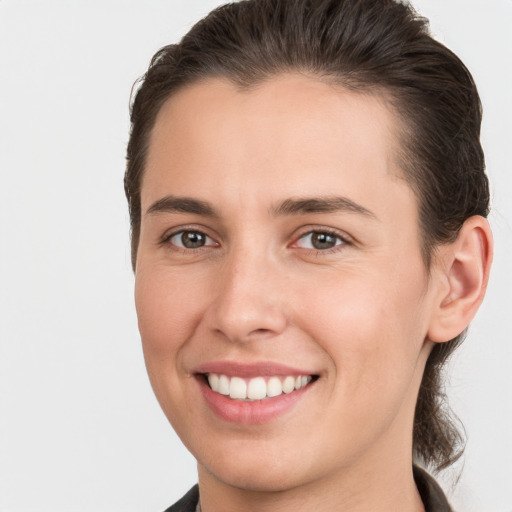 Joyful white young-adult female with medium  brown hair and brown eyes