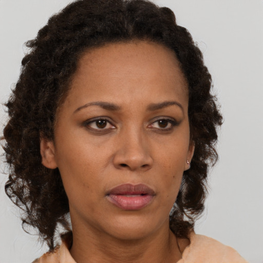 Neutral black adult female with medium  brown hair and brown eyes