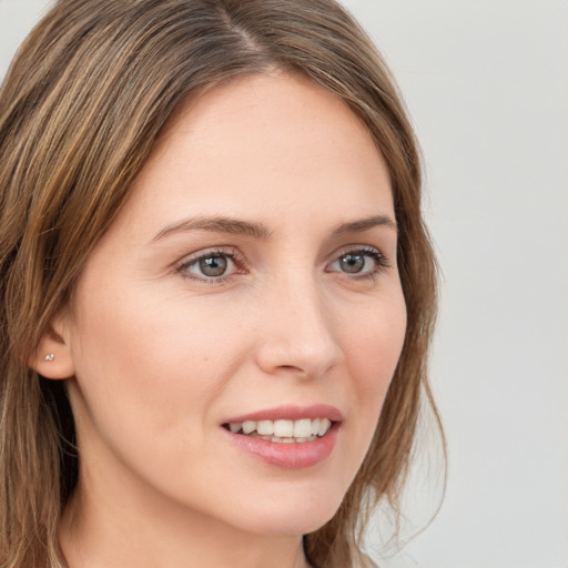 Joyful white young-adult female with long  brown hair and grey eyes