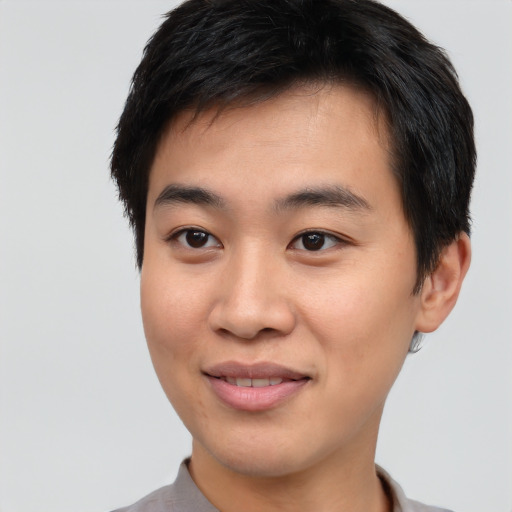 Joyful asian young-adult male with short  brown hair and brown eyes
