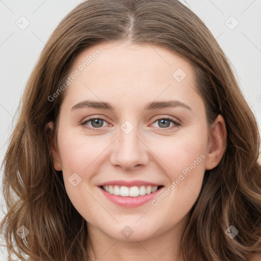 Joyful white young-adult female with long  brown hair and green eyes