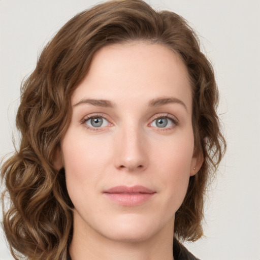 Joyful white young-adult female with medium  brown hair and green eyes