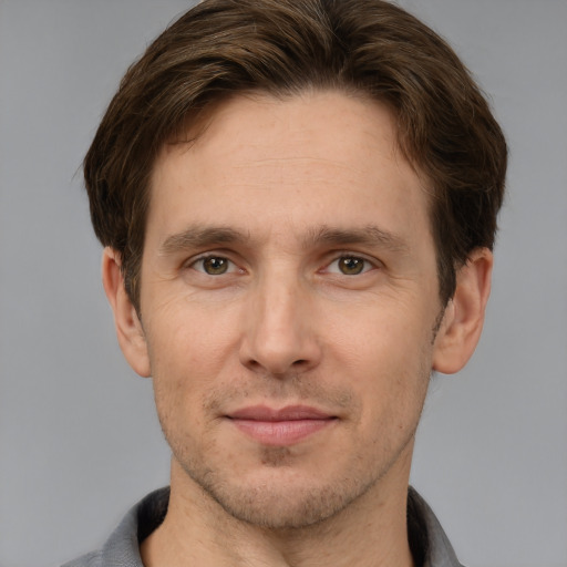 Joyful white adult male with short  brown hair and grey eyes