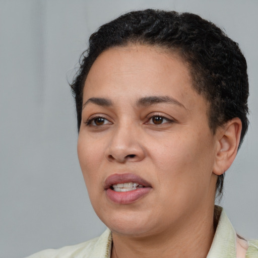 Joyful latino young-adult female with short  black hair and brown eyes