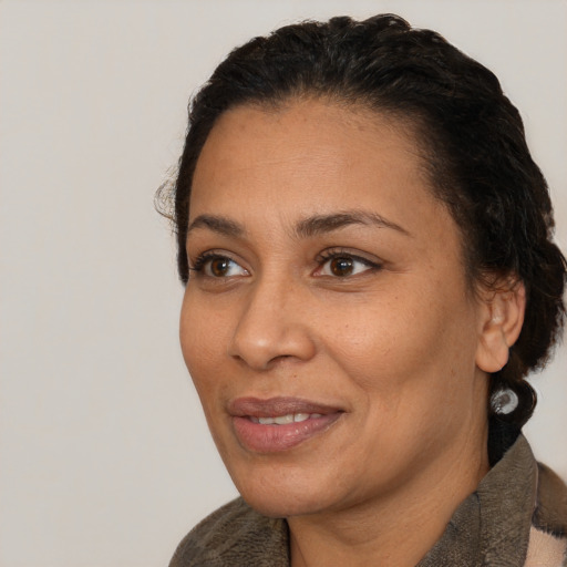 Joyful white adult female with short  black hair and brown eyes
