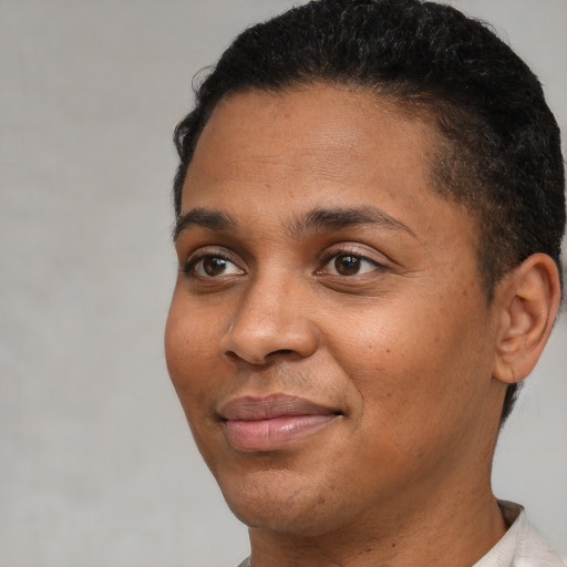 Joyful black young-adult male with short  brown hair and brown eyes