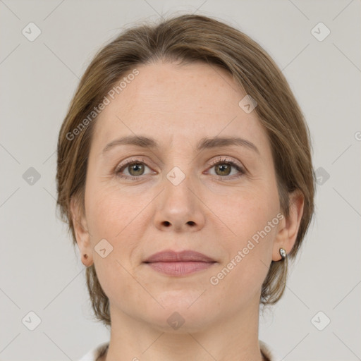 Joyful white adult female with medium  brown hair and grey eyes