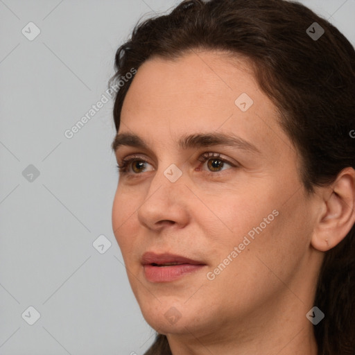 Joyful white adult female with long  brown hair and brown eyes