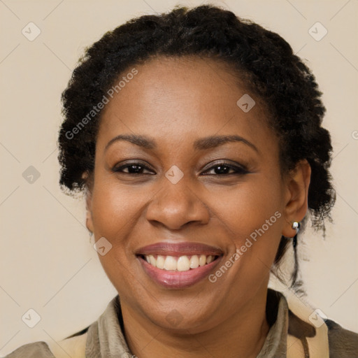 Joyful black adult female with short  brown hair and brown eyes