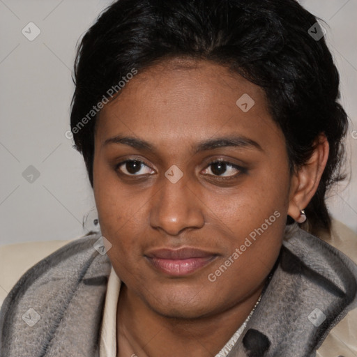 Joyful black young-adult female with short  brown hair and brown eyes