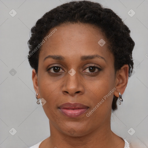 Joyful black adult female with short  brown hair and brown eyes