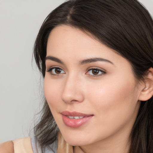 Joyful white young-adult female with long  brown hair and brown eyes