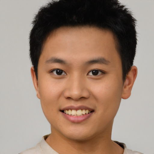 Joyful asian young-adult male with short  brown hair and brown eyes