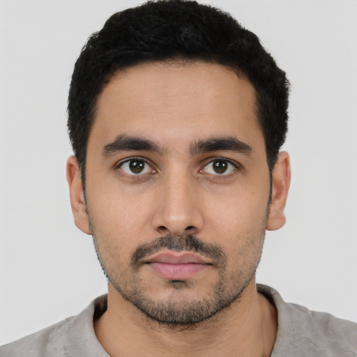 Neutral latino young-adult male with short  black hair and brown eyes