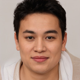 Joyful asian young-adult male with short  brown hair and brown eyes