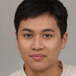 Joyful asian young-adult male with short  brown hair and brown eyes