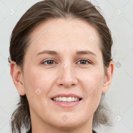 Joyful white young-adult female with medium  brown hair and grey eyes